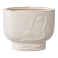 Cache-pot rond en céramique beige mouchetée avec visage abstrait en relief