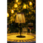 Lampe à poser en rotin ajouré et métal noir, H30 cm, lumière dorée