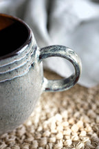 Mug artisanal en grès émaillé vert sauge avec intérieur brun texturé