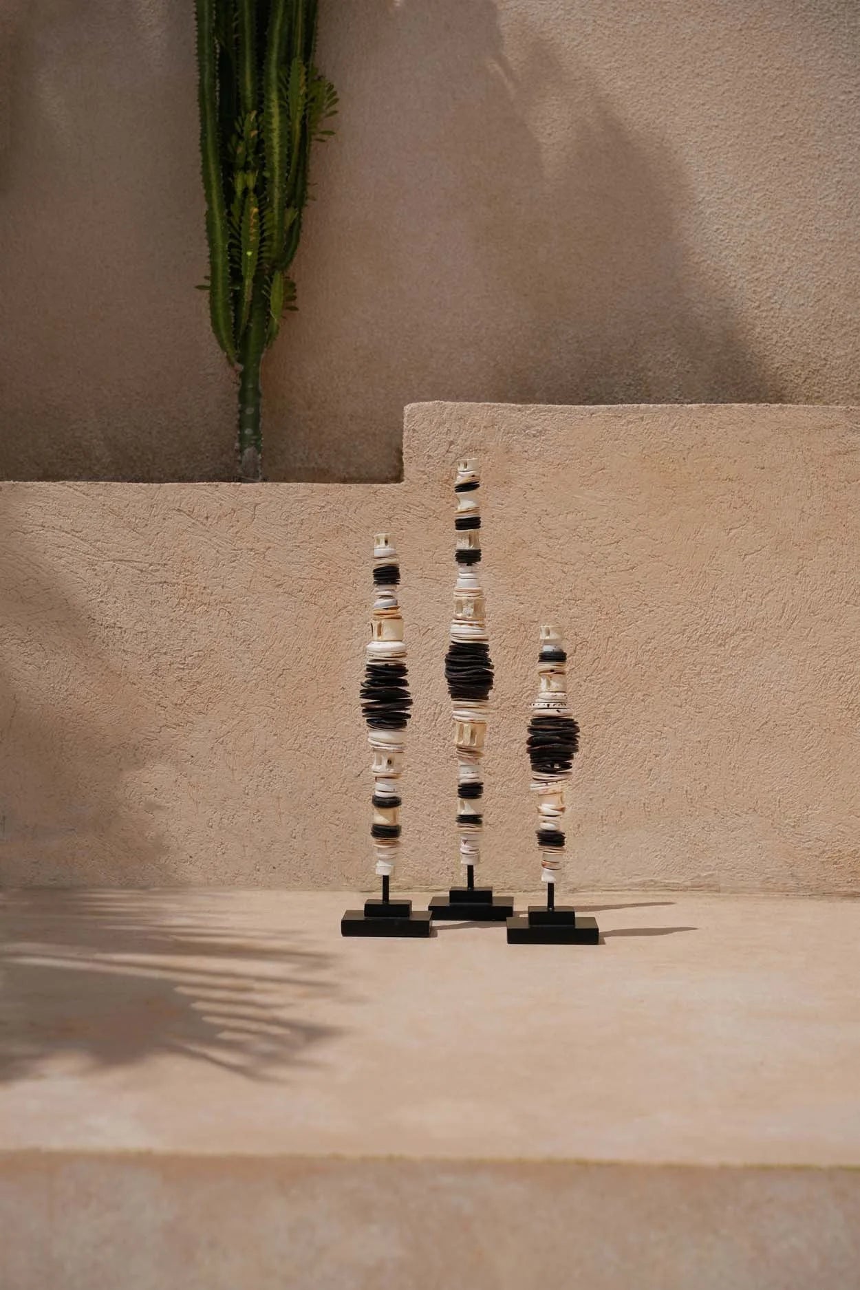 Sculpture tribale en coquillage noir naturel sur support bois