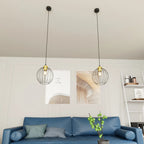 Suspension filaire en métal noir et laiton Ø24 cm pour salon
