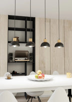 Suspension scandinave noire et bois 4 lumières au-dessus table blanche
