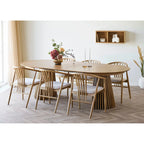 Table ovale en bois clair avec base flûtée et chaises rembourrées blanches